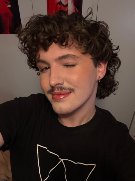 Image may contain Face Head Person Body Part Neck Curly Hair Hair and Teen